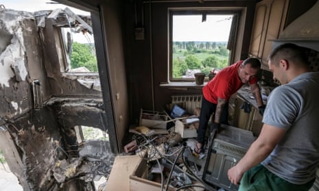 Local residents collect unbroken items at apartment inside a residential building destroyed by Russian airstrike in the Borodyanka town, Kyiv area, Ukraine.