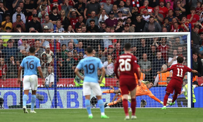 Liverpool player Mohamed Salah hits the net from a penalty kick to score the second goal.