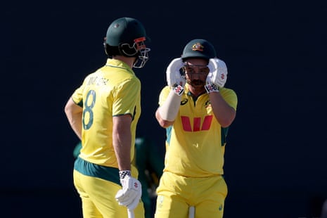 Travis Head talks with captain Mitch Marsh