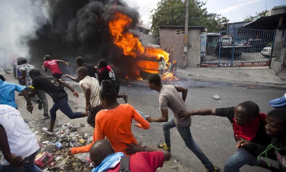 Demonstrators flee police gunfire during protests in Port-au-Prince demanding the resignation of Jovenel Moise, the Haitian president
