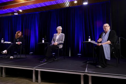 three candidates sit on stage
