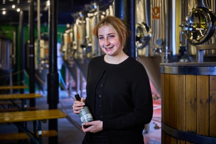 Katie Thorp smiles as he holds a bottle at the Bollington Brewing Company