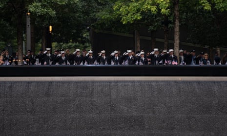 Firefighters salute during a moment of silence (observance of time of the fall of the South Tower) at the World Trade Center Memorial in New York.