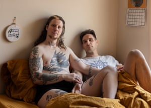 Zev and Nick pose together in bed.
