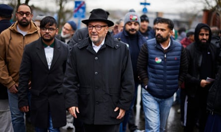 George Galloway walking with a group of supporters