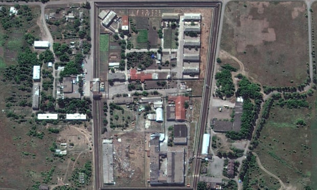 A satellite photo of the Olenivka detention centre a walled compound of buildings showing damage from an attack