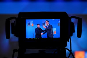 A camera screen displays a view of Ukraine’s president Volodymyr Zelensky (L), and Nato secretary general Mark Rutte shaking hands prior to a Nato meeting at World Forum convention centre in The Hague, Netherlands