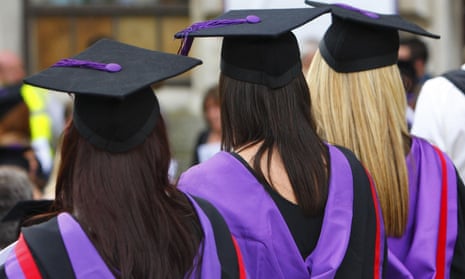 three female graduates in graduation ceremony attire with their backs to the camera