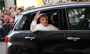 Pope Francis waves to the crowds from his Fiat, driving down Fifth avenue on his way to Saint Patrick’s Cathedral.