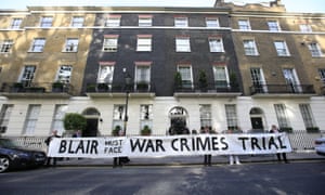 Protesters hold a banner outside the London home of Tony Blair.