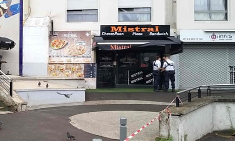 Policemen stand in front of the eatery where a waiter was shot dead by a customer allegedly angry at having to wait for a sandwich, in the eastern Paris suburb of Noisy-le-Grand.