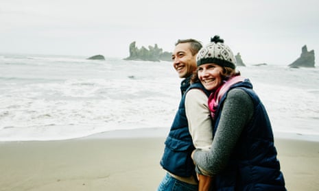 Couple laughing and embracing on a beach
