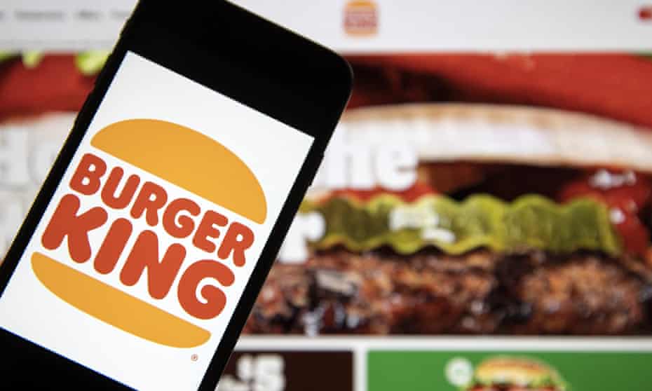 A laptop screen displays order page of Burger King and a smartphone displays the new logo