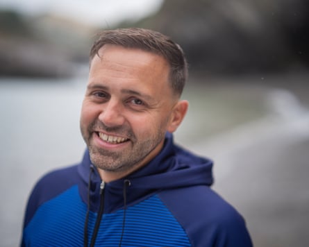 Neil Gilson in a blue tracksuit top in a cove