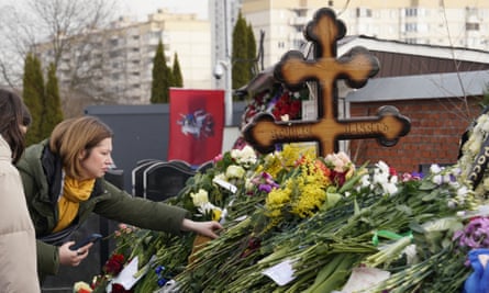 People mourn at the grave of Russian opposition leader Alexei Navalny.