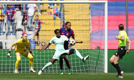 The ball hits the arm of Chelsea's Kadeisha Buchanan as she vies for the ball with Barcelona's Salma Paralluelo.