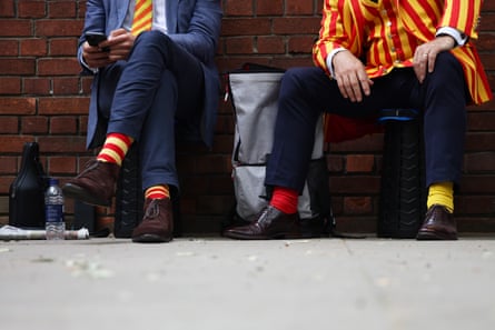 MCC members show off their distinctive socks outside the ground