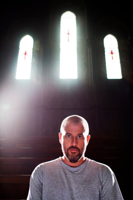 Frey sits in the Union chapel, London, beneath three windows with stained-glass crosses