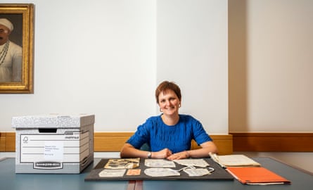 Helen Melody at desk with documents