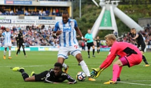 Huddersfield’s Mathias Jorgensen avoids the foul, leaving his keeper Jonas Lossl to collect from the threat of Leicester’ Demarai Gray during the 1-1 draw at The John Smith’s Stadium.