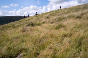 Hikers stroll through the hills near Dovestone reservoir in the north Peak District.