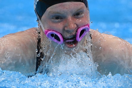 Lydia Jacoby, with her goggles around her mouth, competes in the final of the mixed 4x100m medley relay swimming event.