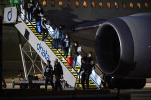 Tennis players and officials arrive on a charter flight in Melbourne on 14 January