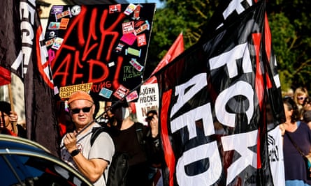 Man holds banner saying ‘fuck AFD’