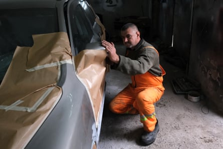 Volodomyr Horbach, 45, in his car workshop in the village of Zalissia at the edge of the forest north east of Kyiv.