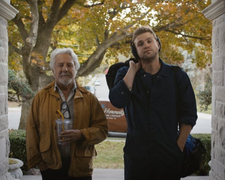 Dustin Hoffman and Leo Woodall standing in a doorway waiting to be asked inside