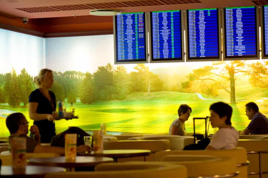 Passengers relax before departure at the cafe bar at Fryderyk Chopin Airport Warsaw.