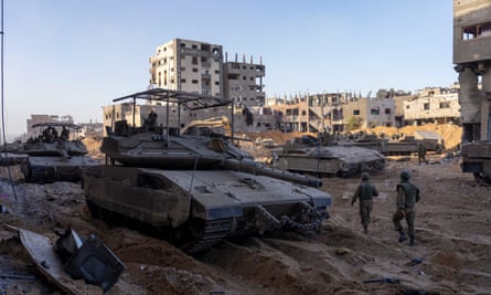 Israeli army troops next to a destroyed building during a ground operation in the Gaza Strip on Wednesday 8 November.