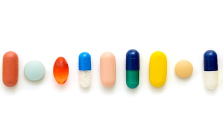 Coloured capsules and tablets against a white background.