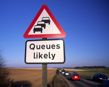 Road sign showing cars queuing with the words ‘Queues likely’