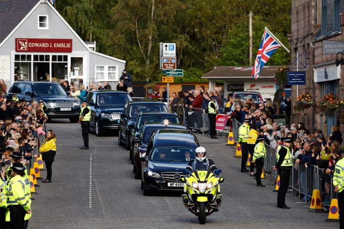 People gather in tribute as the cortege passes through Ballater.