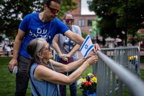 People lay flowers and an Israeli flag at the site of the attack outside the Boulder county courthouse on Monday in Boulder, Colorado.