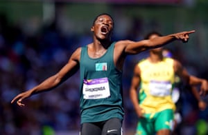 Zambia’s Muzala Samukonga wins his 400m heat on the opening morning of the athletics program in the stadium.