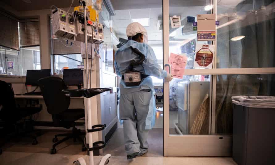 A nurse enters the room of a Covid-19 patient in the ICU of Sharp Grossmont hospital in La Mesa, East of San Diego, California