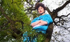 Annie Mac in turquoise tracksuit up a tree