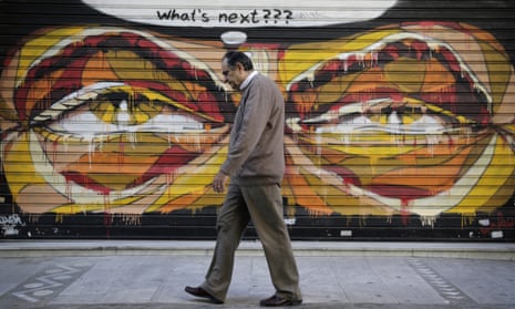 A man walks past graffitti with a thought bubble asking 'what's next?'