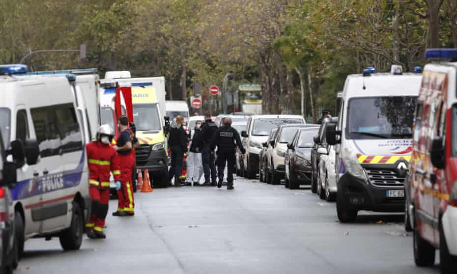 Police at the scene of the knife attack near the former offices of satirical newspaper Charlie Hebdo in Paris.