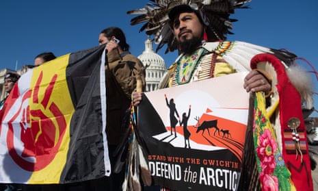Native American leaders hold signs against drilling in the Arctic refuge outside the Capitol in Washington DC on 11 December. 