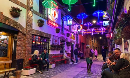 Neon umbrellas in alleyway outside pub