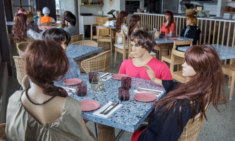 Mannequins around the table of a cafe in Auckland that has been required to close.