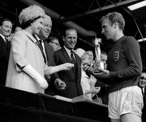 1966: the England captain Bobby Moore holds the Jules Rimet trophy, collected from the Queen, after leading his team to a 4-2 victory over West Germany in a historic World Cup final that went to extra time at Wembley stadium in London