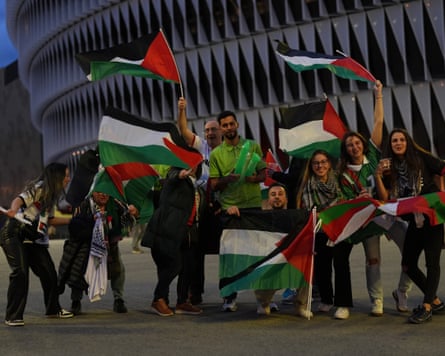 Fans of Palestine pose for a photo near the stadium.