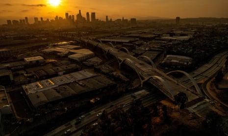 An aerial view of the Sixth Street viaduct with the skyline of downtown Los Angeles in the background.