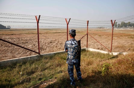 An armed policeman stands guard near the fence of the Taungpyo Bangladesh-Myanmar border gate where the repatriation process is planned to take place.