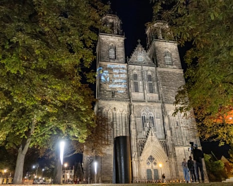 Avaaz activists illuminate the facade of the Magdeburg Cathedral with the lettering 'Elected offcials, say 'No' to an AFD Premier in the state parliament' during a light projection.