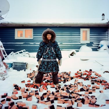 The photograph embodies the traditional values that enable survival in a harsh environment - subsistence hunting and food sharing